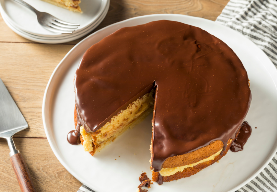 Image of a Boston cream pie with a slice removed